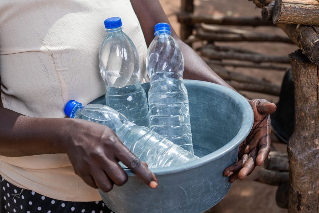 A lady carrying SODIS bottles