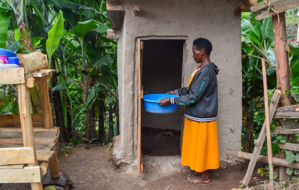 Midius stands nexts to their new bathroom