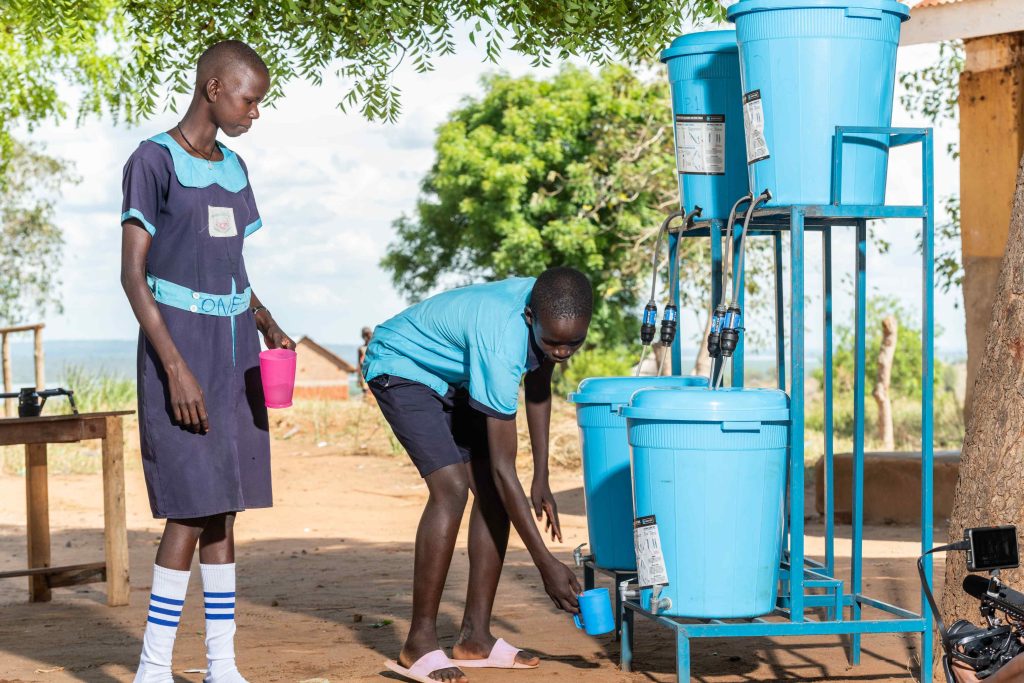 Students drawing water from a Sawyer filter 1