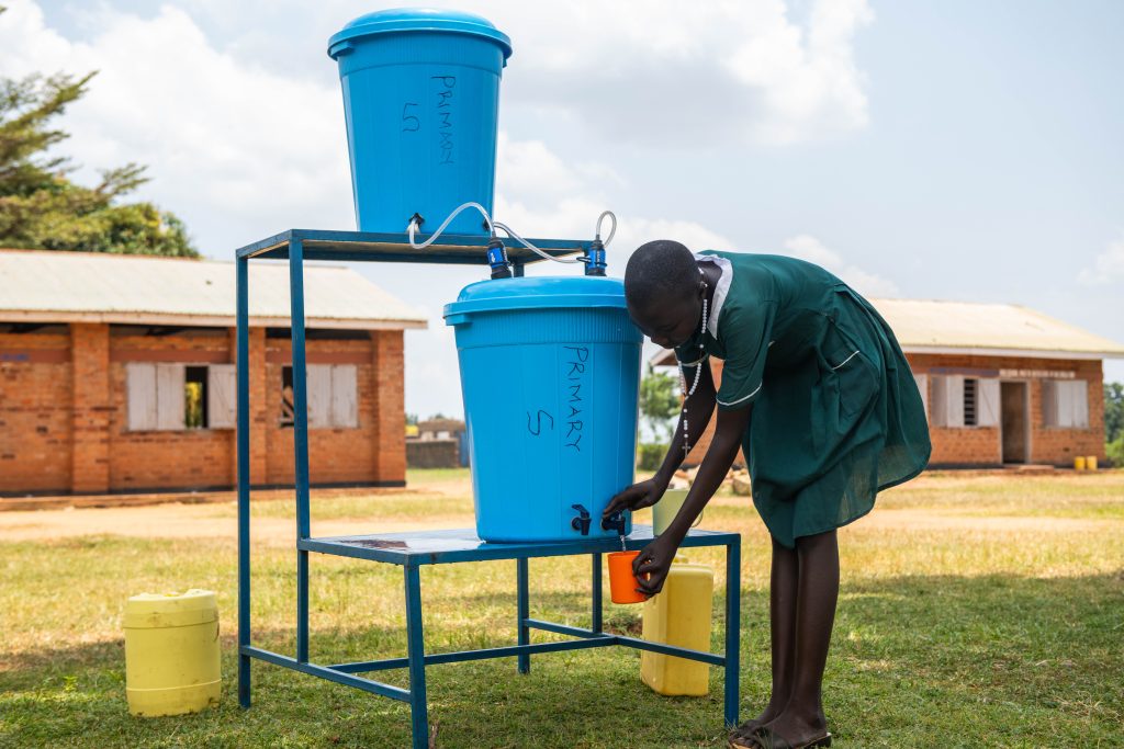 A girl pouring water into a cup