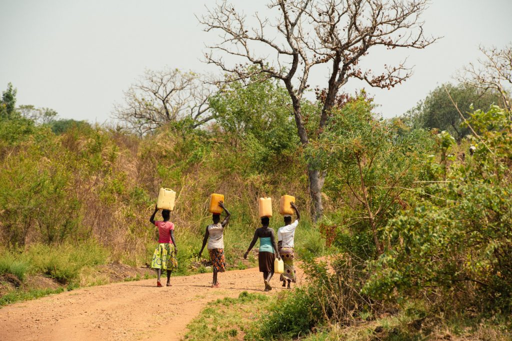 Women in Ndima carrying jerrycans on their heads