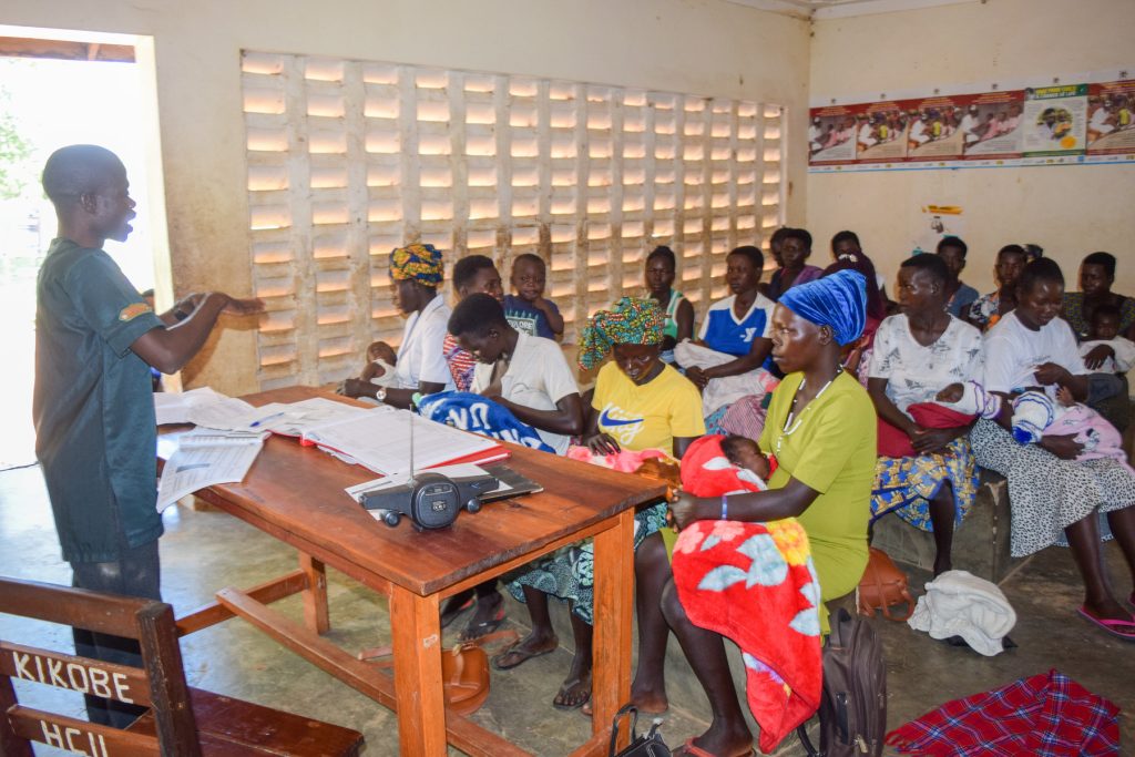 Patients listening to a nurse at Kikobe HC II