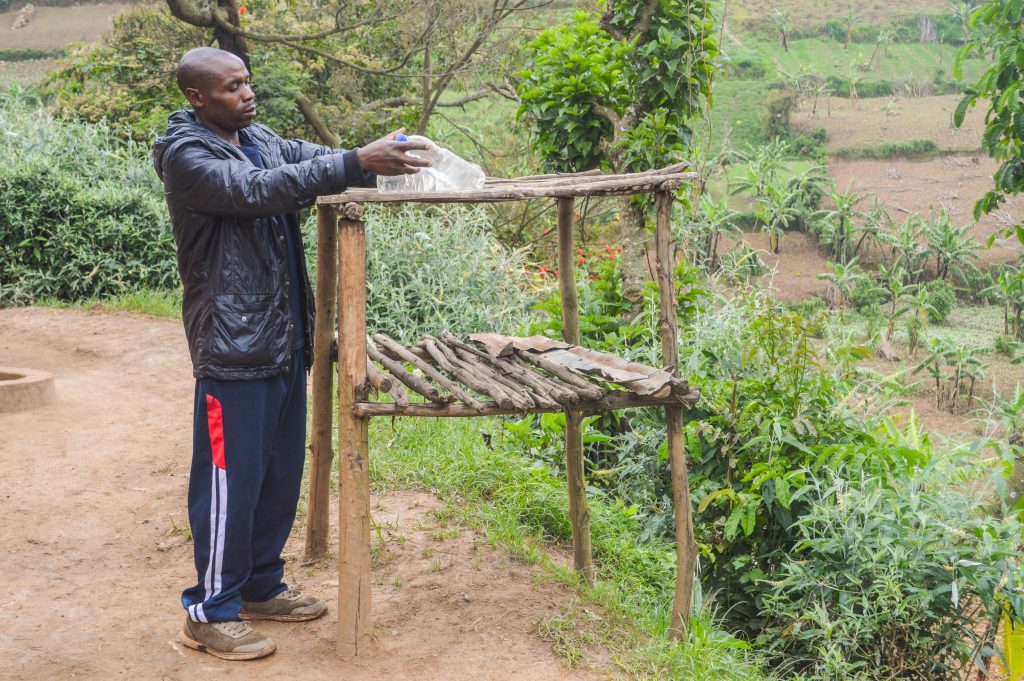 Gad placing SODIS bottles onto a rack