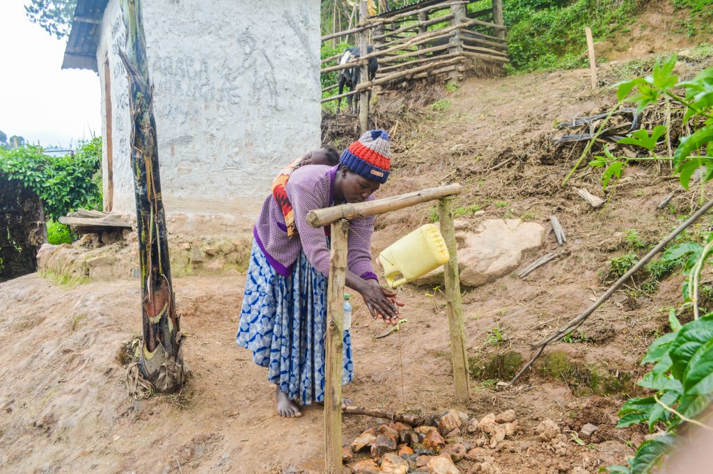 Gad's wife using a newly installed tippy tap