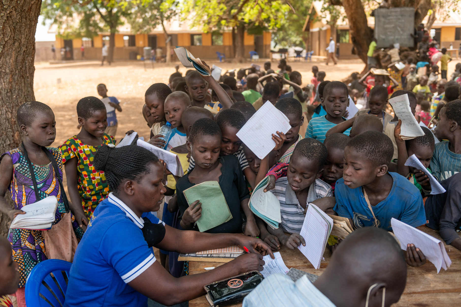 A teacher marks the childrens class books