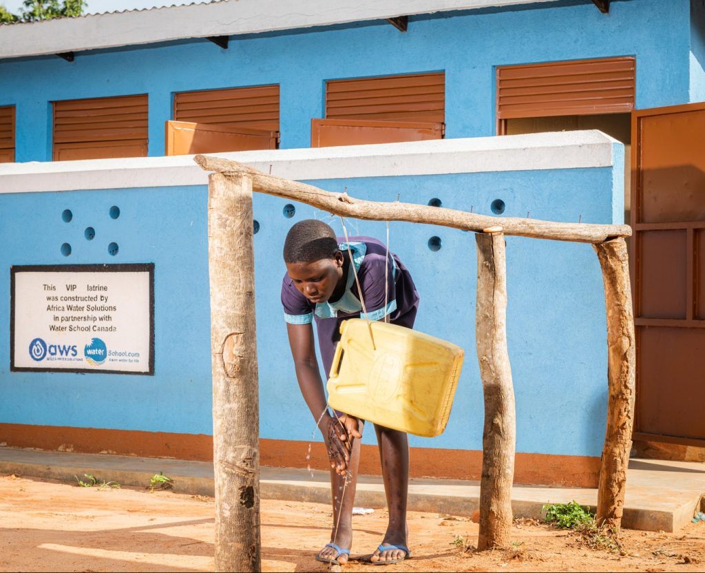A girl using a tippy tap